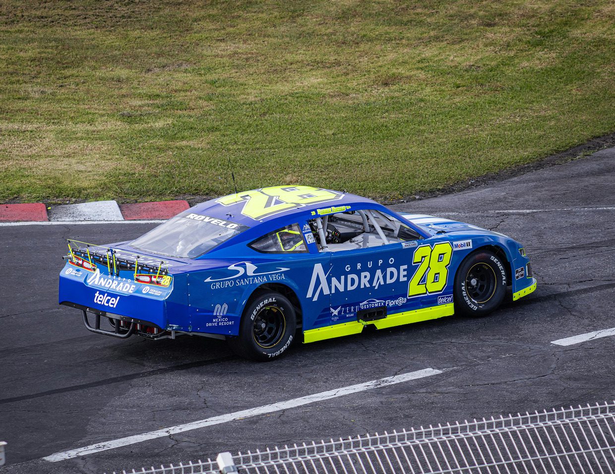 Blue race car on a track corner.