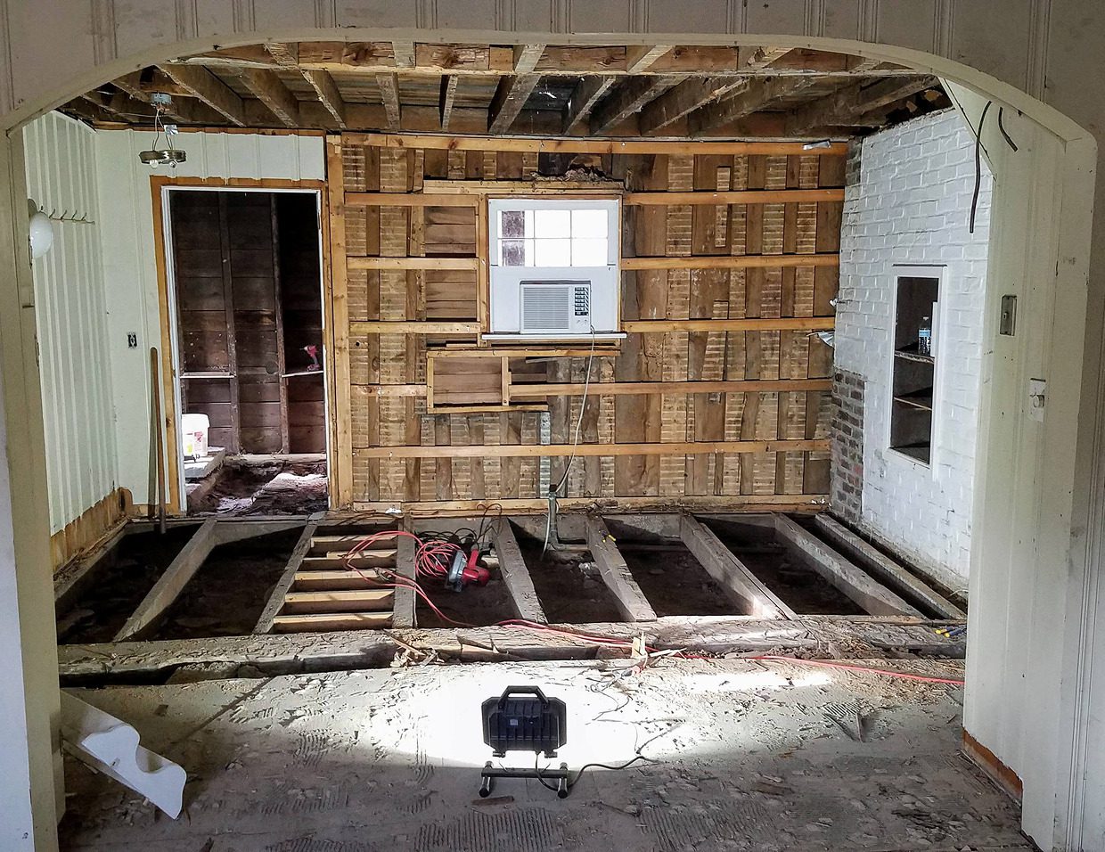 Room under renovation with exposed wooden beams.
