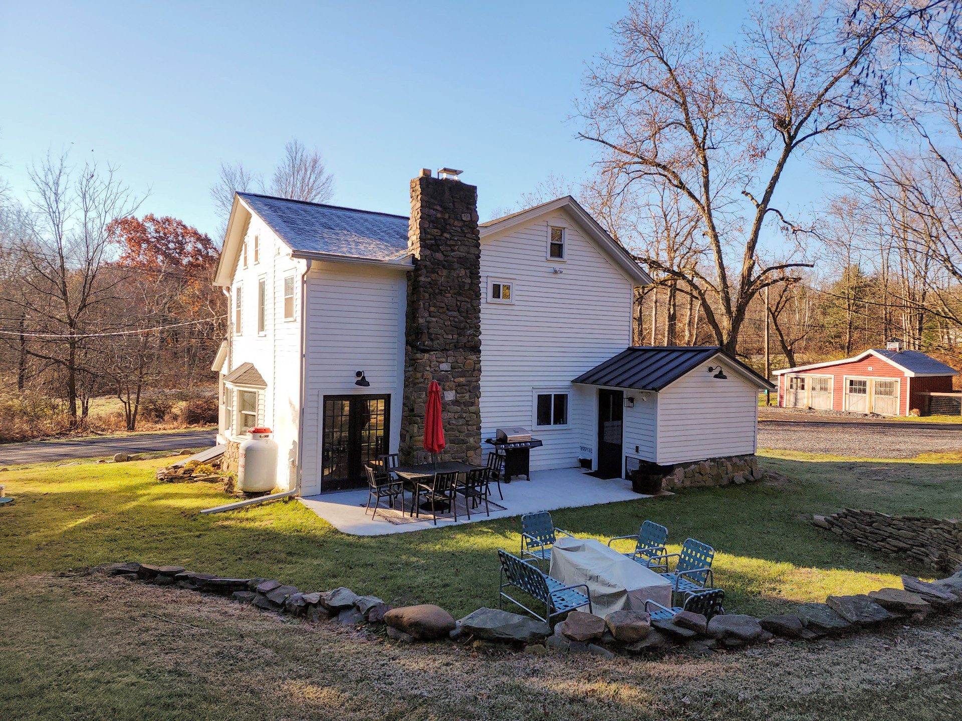 White house with patio and outdoor seating.