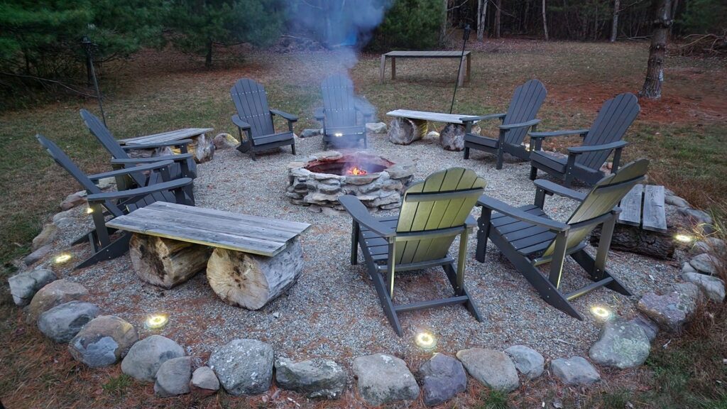 Outdoor fire pit with Adirondack chairs.
