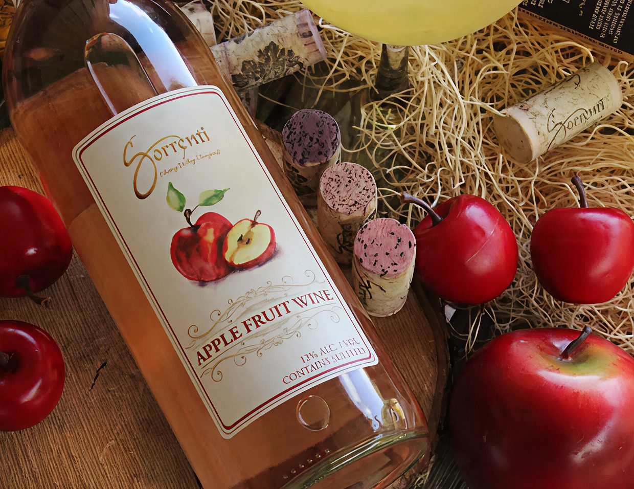 Apple fruit wine with corks and apples.